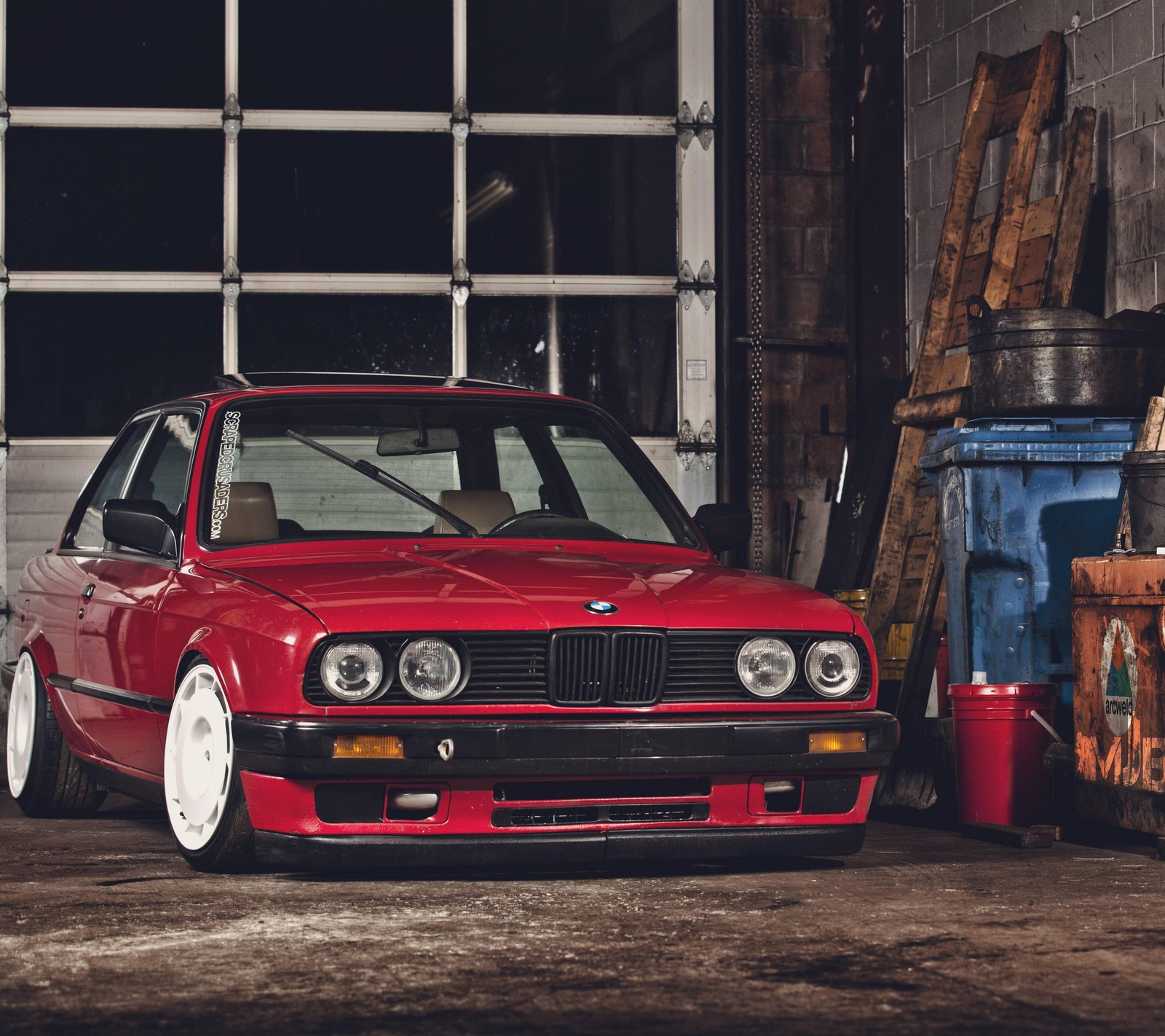 A close up of a red car parked in a garage (car, garage, retro, sport, tuning)