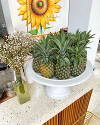 Fresh Pineapples Displayed with Floral Accents