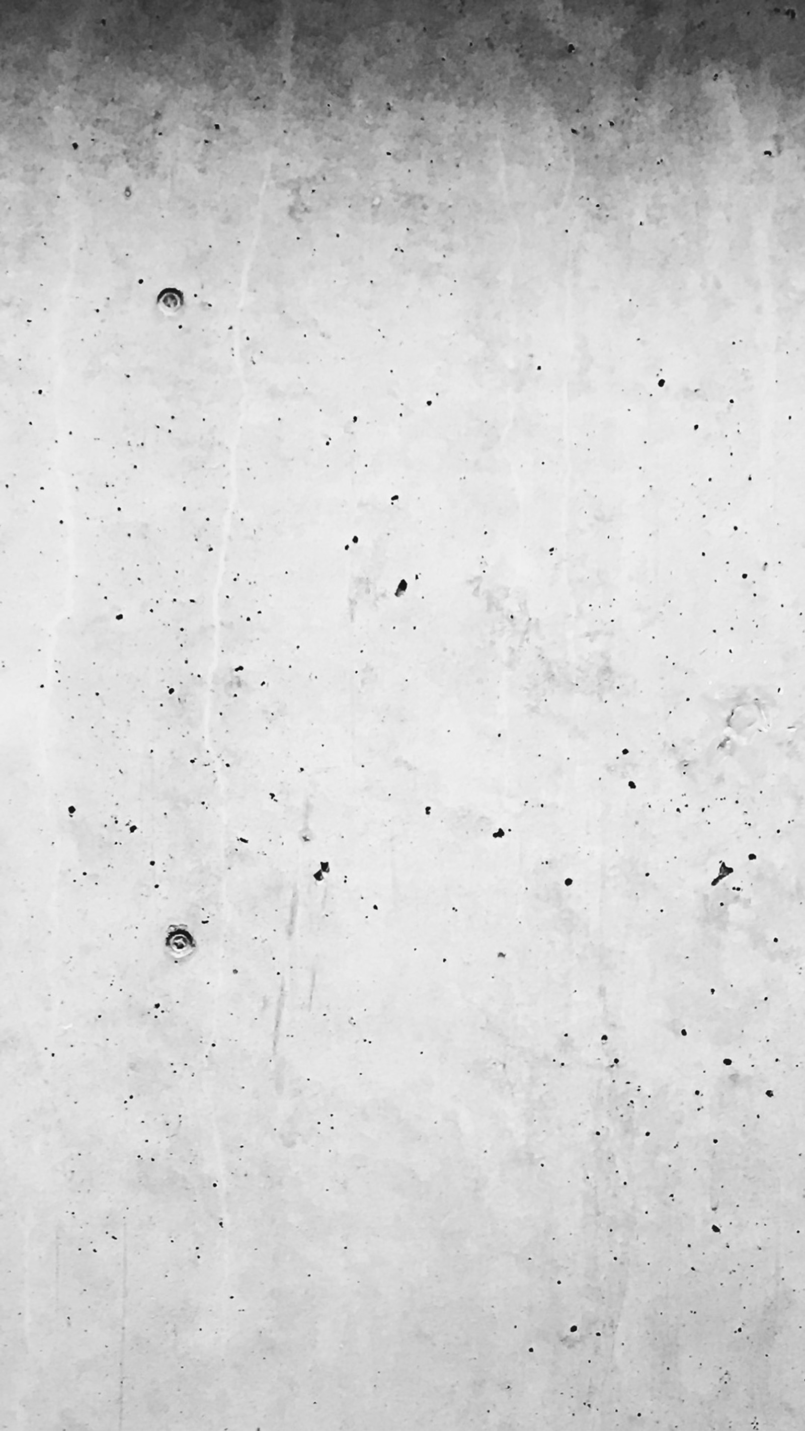 A close up of a black and white photo of a wall (clean, concrete, cool, grey, light)