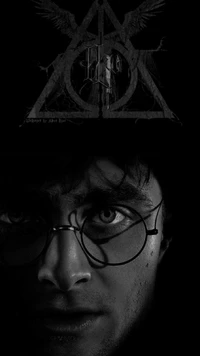 A monochromatic portrait of a young wizard with round glasses, set against a mysterious symbol featuring a triangle, circle, and wings, evoking themes of magic and destiny.