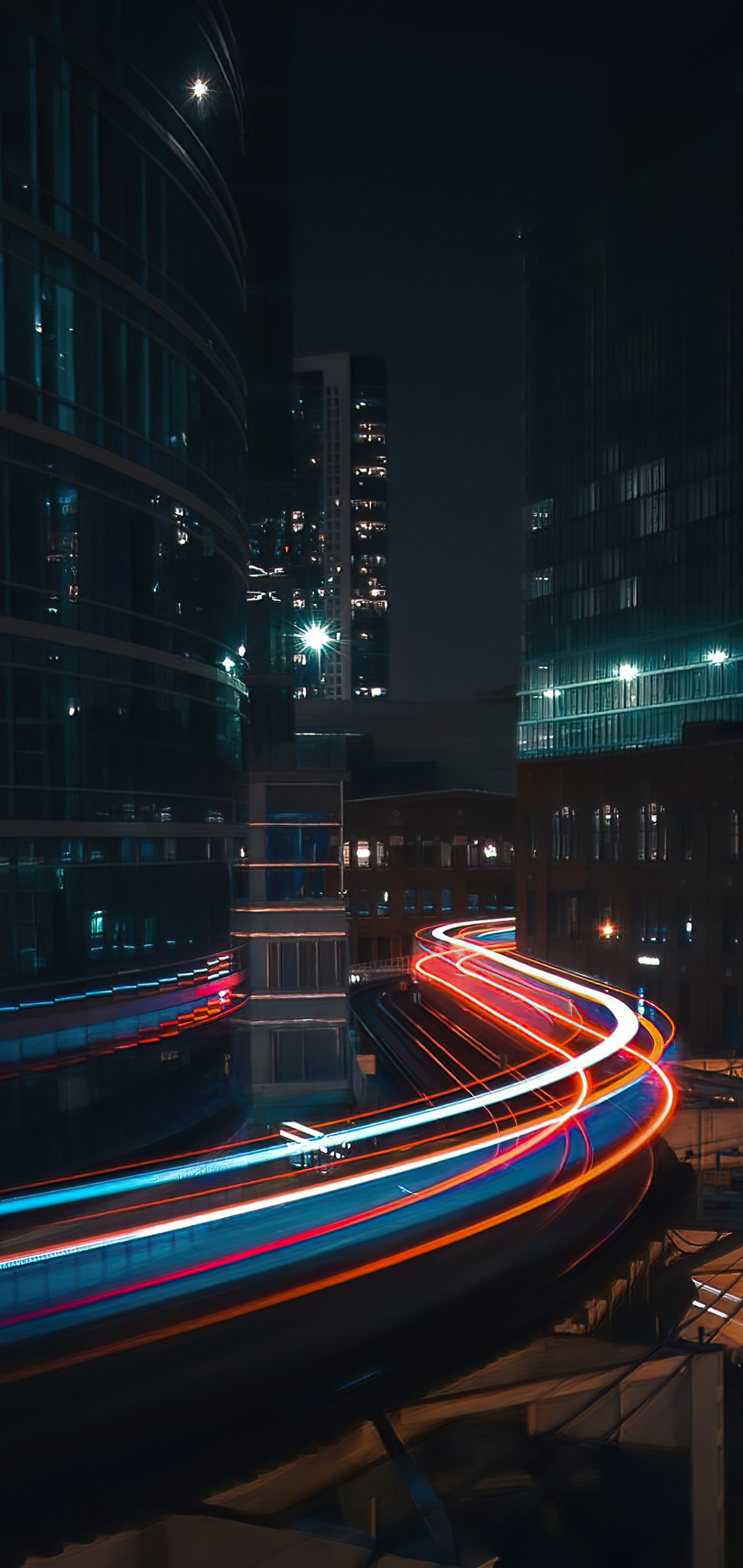 Arafed view of a city at night with a long exposure of light trails (cityscape, building, skyscraper, automotive lighting, electricity)