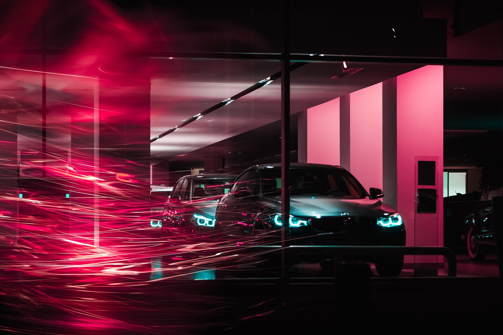 Cars are parked in a parking garage with a pink light (car, light, lighting, pink, magenta)