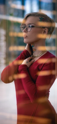 Fashionable Individual in Red Dress with Sunglasses and Unique Hairstyle