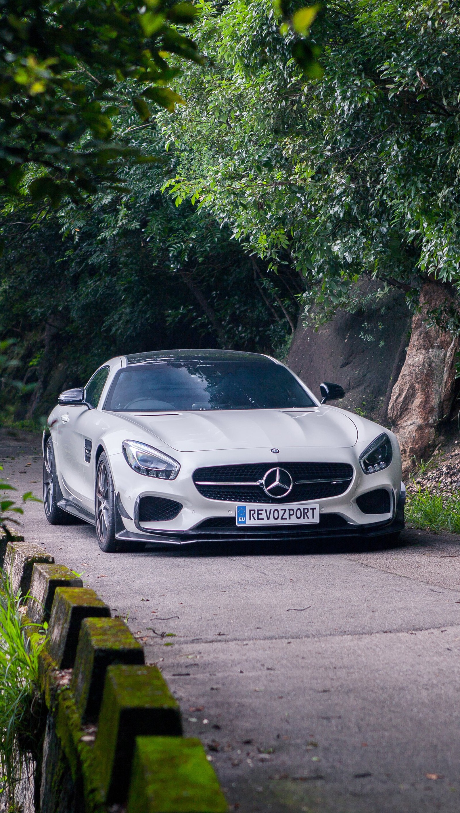 A close up of a white mercedes sports car parked on a road (amg, car, mercedes)