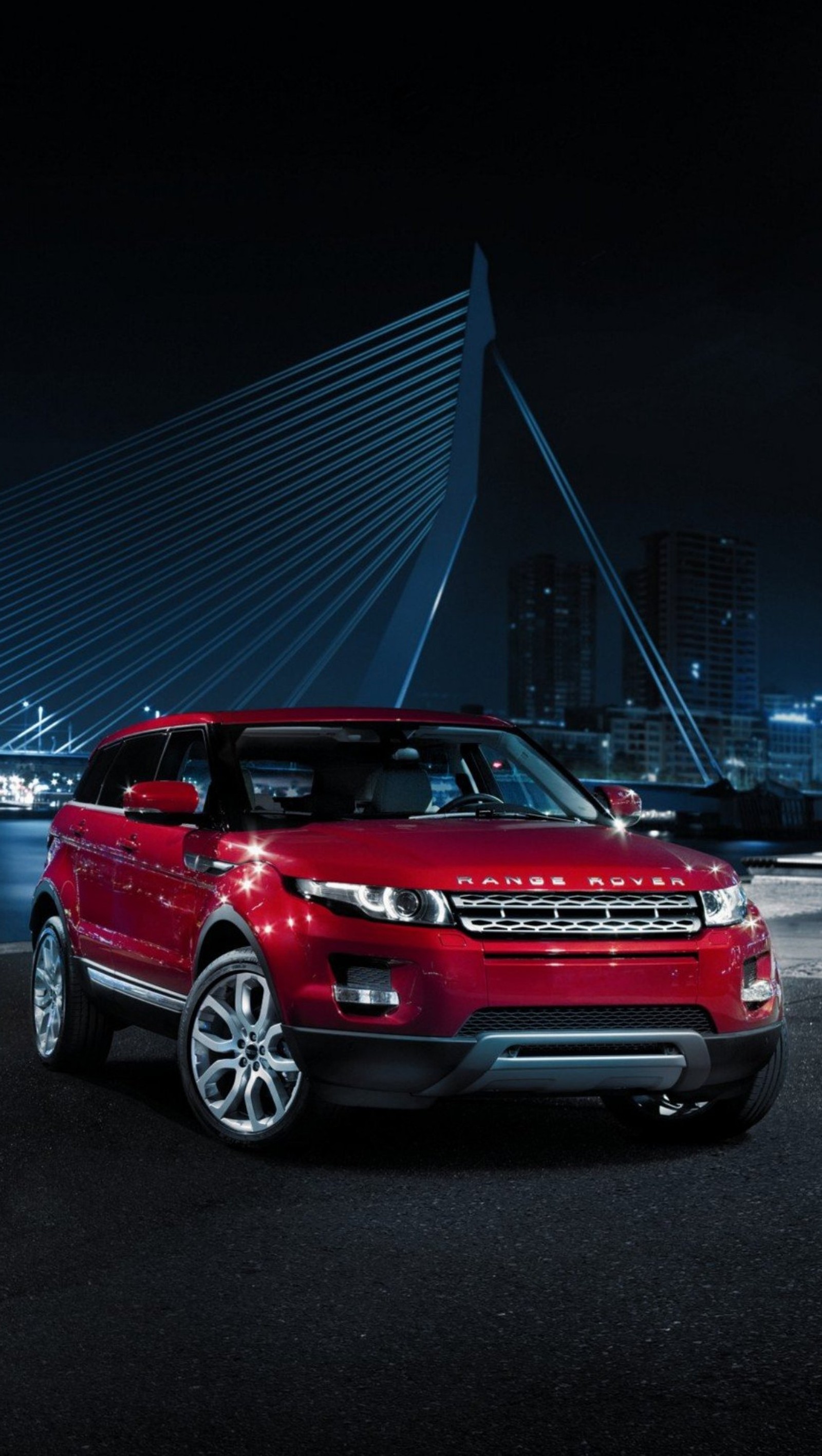 A red range rover parked in front of a bridge at night (car, night, range rover, red)