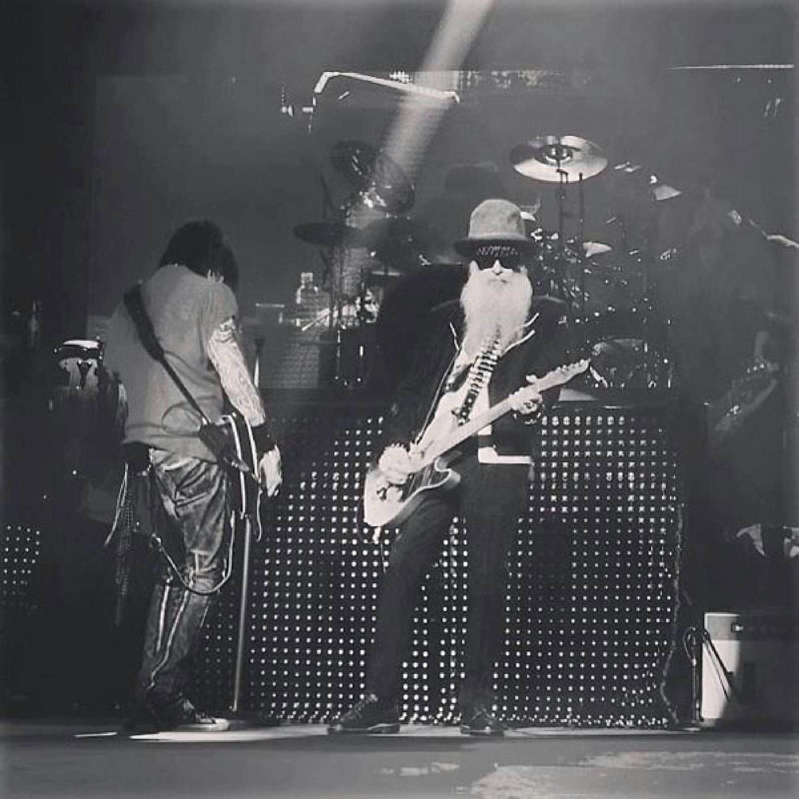 Arafed black and white photo of two men playing guitar (guitar, string instrument, musical ensemble, black, performance)