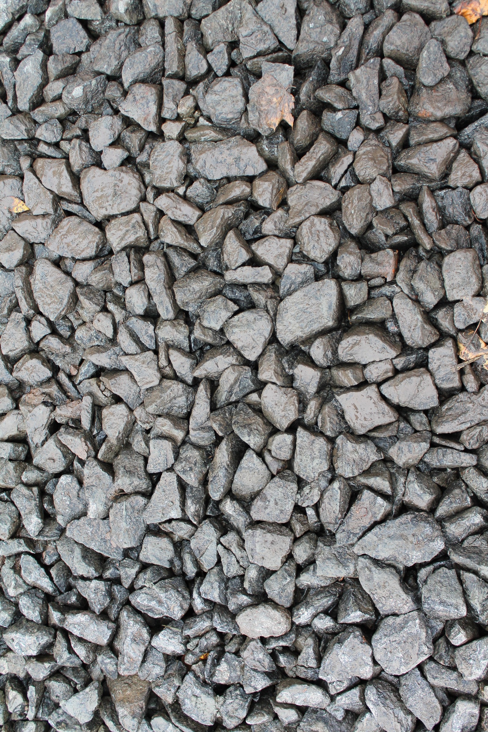 A close up of a pile of rocks with a red fire hydrant (stone wall, stone, granite, rock, gravel)