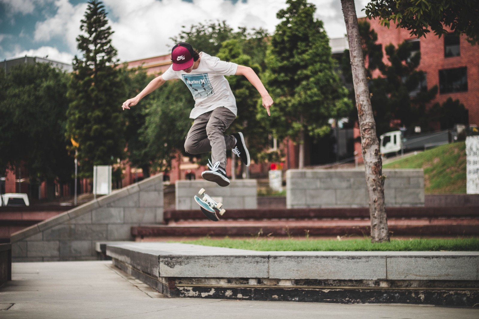 Arafed skateboarder in mid air doing a trick on a concrete ledge (skateboarding, skateboard, boardsport, skateboarder, recreation)