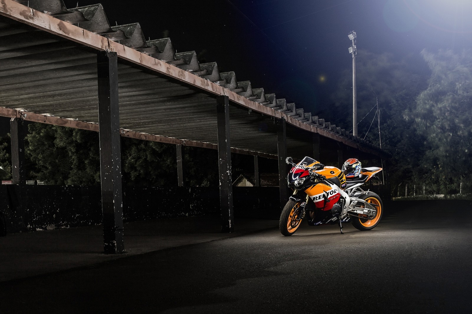 There is a motorcycle parked under a bridge at night (motorcycle, motorcycling, motorcycle racing, motorsport, night)