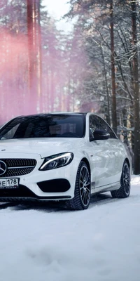 Mercedes-Benz parked in a snowy forest, surrounded by pink smoke.