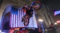 Russell Adler Performing a Stunt on a Motorcycle Amidst a Police Scene