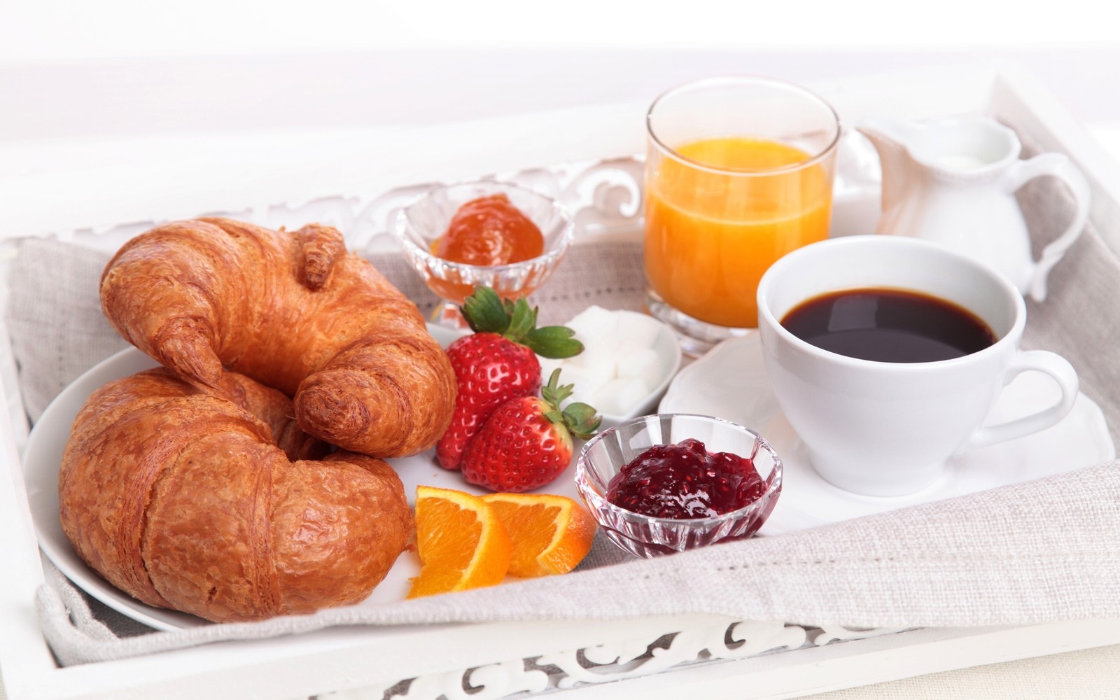 Il y a un plateau avec de la nourriture et une tasse de café (petit déjeuner, croissant, table, nourriture, brunch)