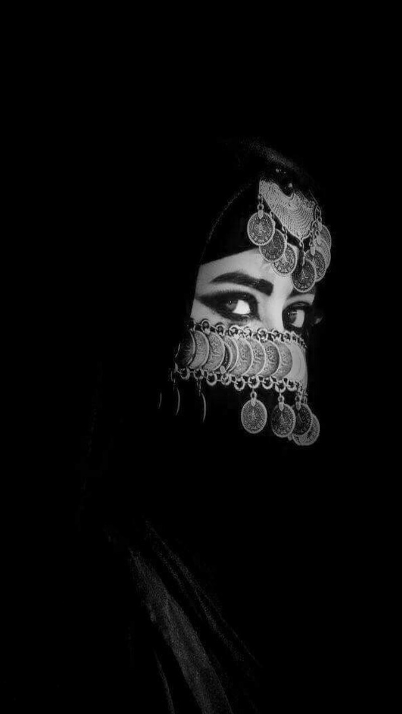 A close up of a woman wearing a veil and a face mask (arabian, black, women)