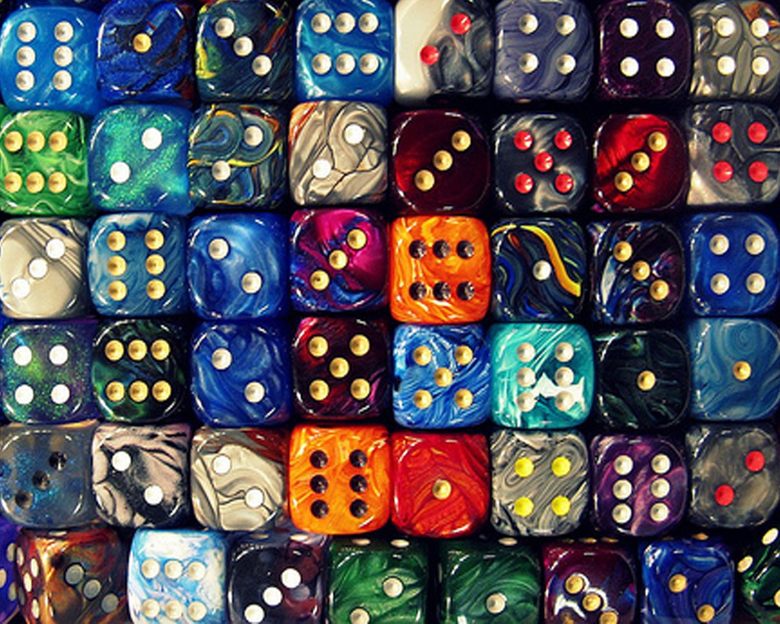 A close up of a pile of colorful dice sitting on top of a table (abstract, awesome, colorful, design, game)