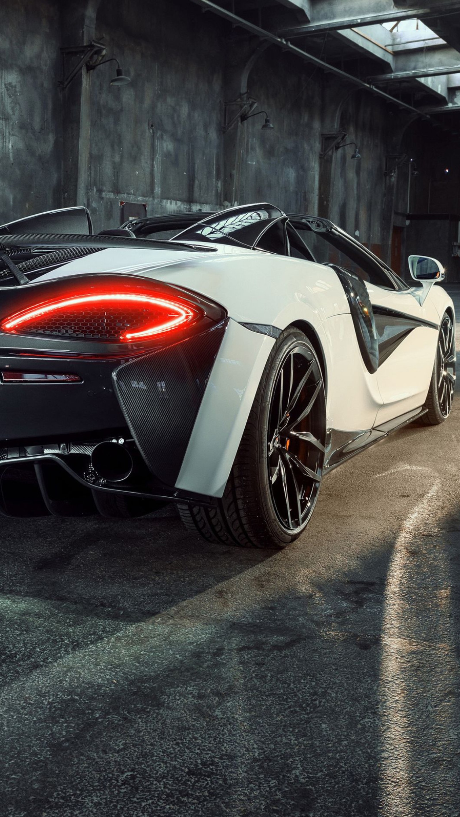 A close up of a white sports car parked in a garage (auto, back, car, fast, garage)