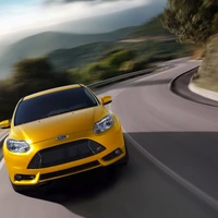 Dynamic curves of a yellow Ford racing along a winding road.