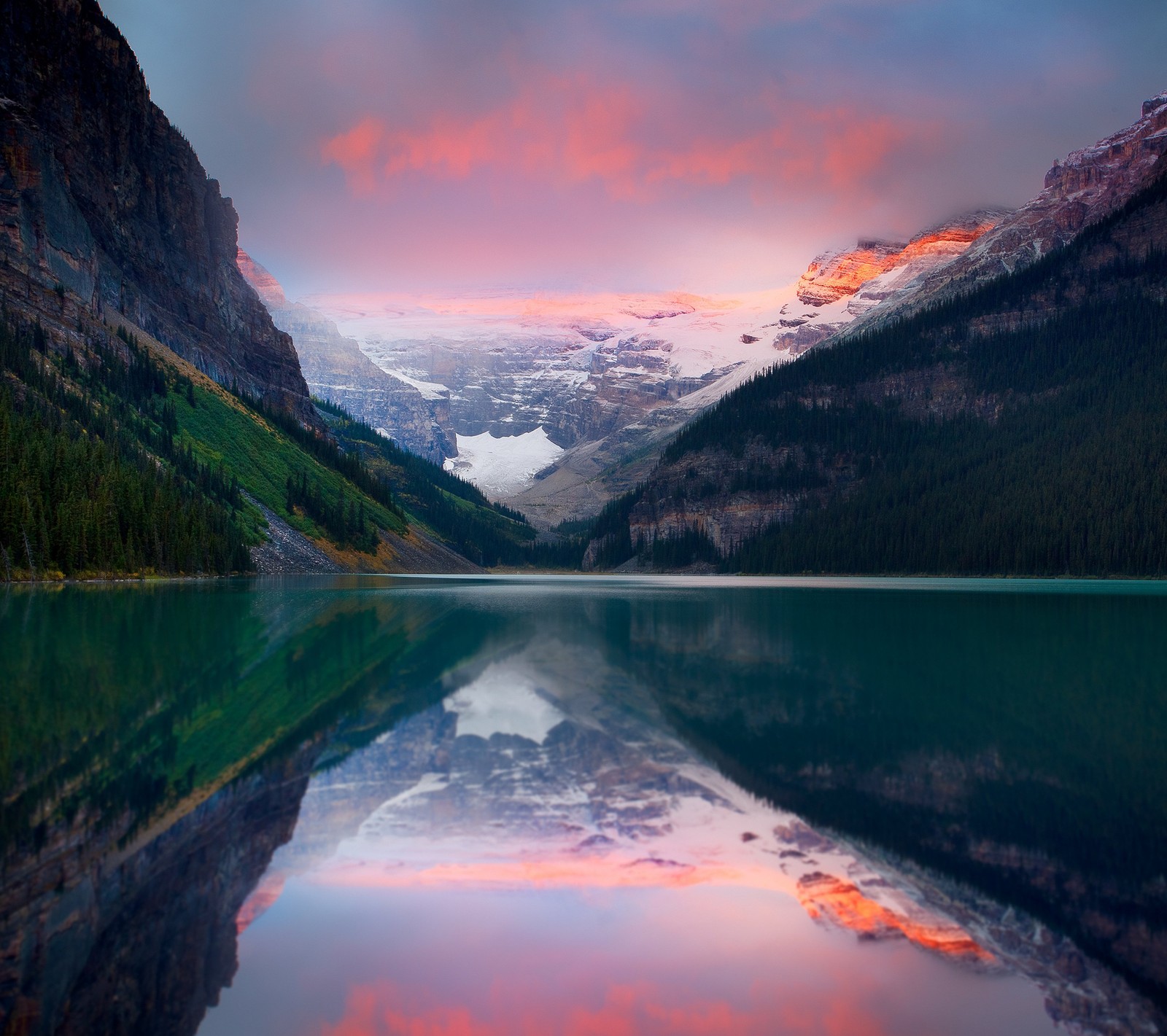 A view of a mountain range with a lake and a mountain range in the background (lake, mountains, reflections, sky)