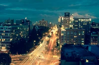 Illuminated Urban Nightscape with Skyscrapers and Light Trails