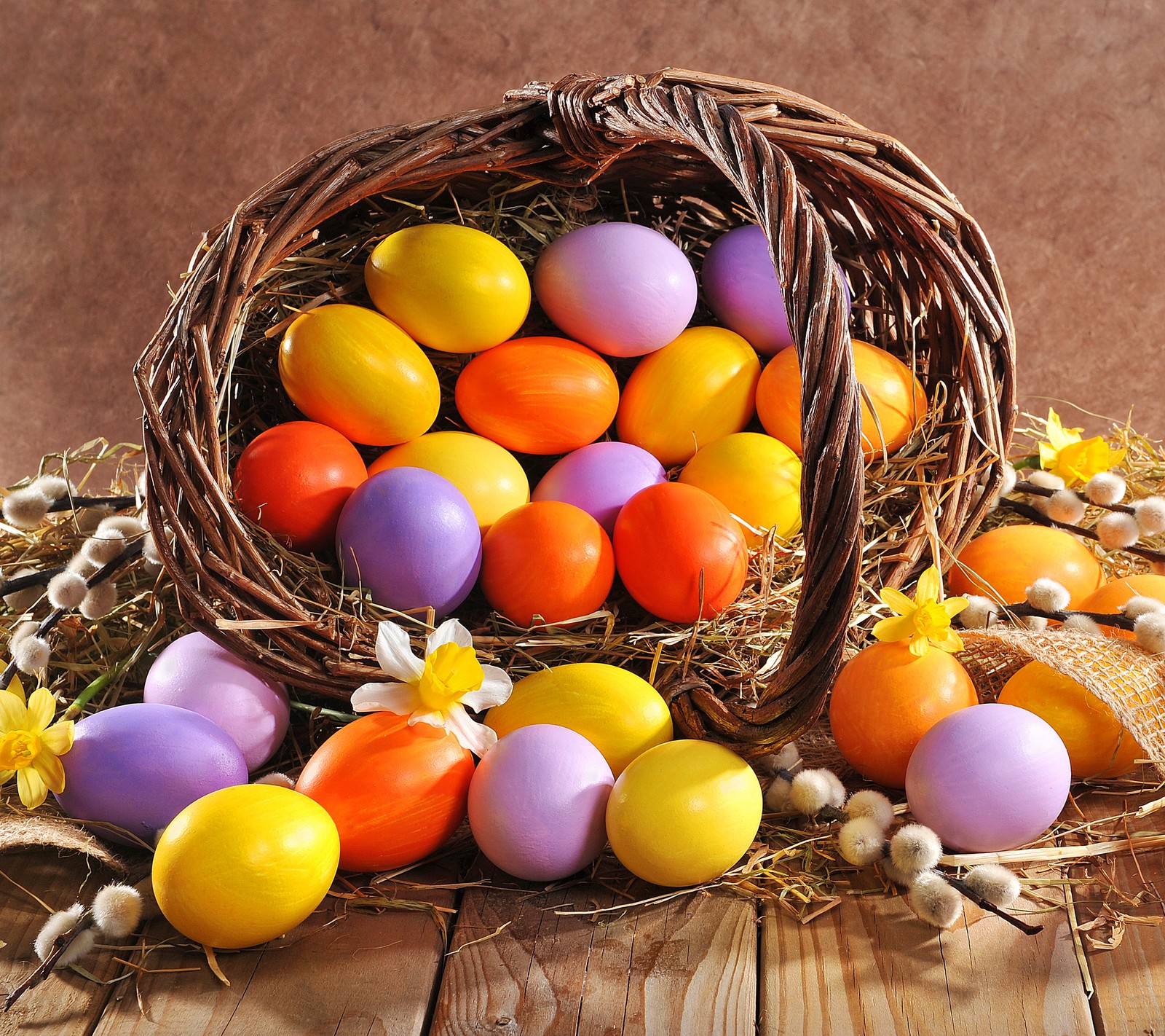 A close up of a basket filled with lots of colorful eggs (basket, easter, egg)