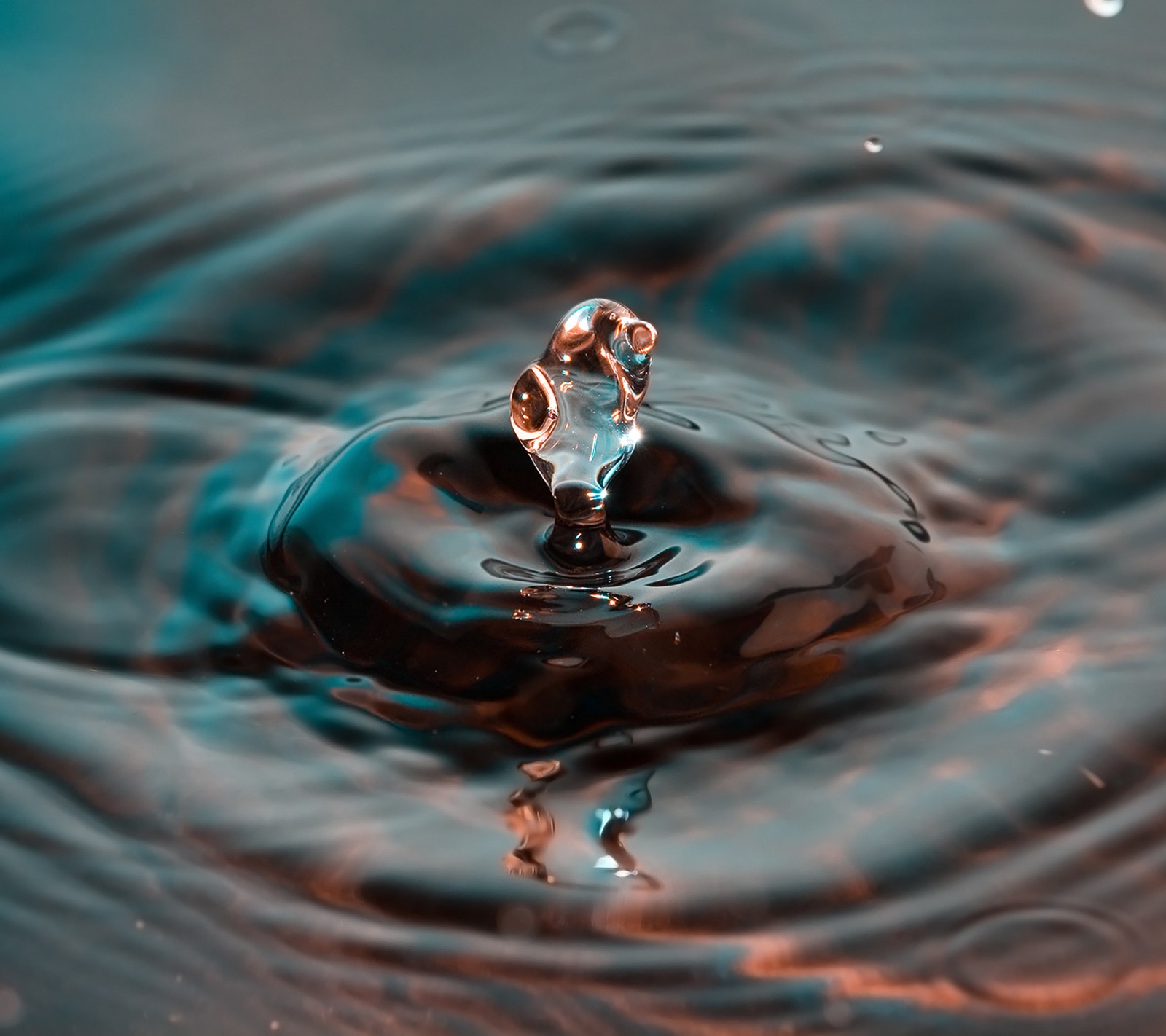 A close up of a water drop with a person standing on it (drop, droplet, water, water drop)