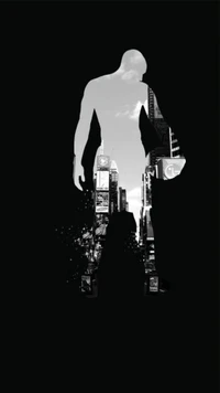 Silhouette of a basketball player against a cityscape backdrop.