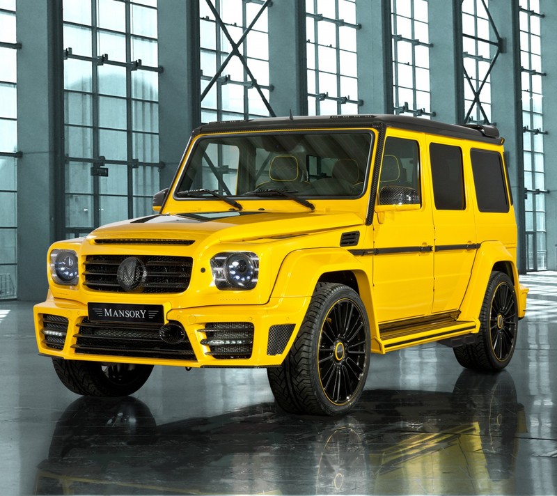 A close up of a yellow mercedes g - class parked in a building (auto, benz, german, mercedes, tuned)