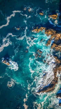 Azure Waves and Rocky Coastline: Aerial View of Coastal Water Resources