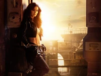 Disha Patani em um cenário futurista, incorporando força e estilo contra um fundo de pôr do sol para o anúncio da Kalki 2898.