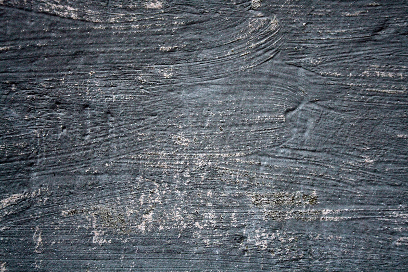 A close up of a black wooden surface with a pattern of lines (wood, bedrock, black, black and white, tar)