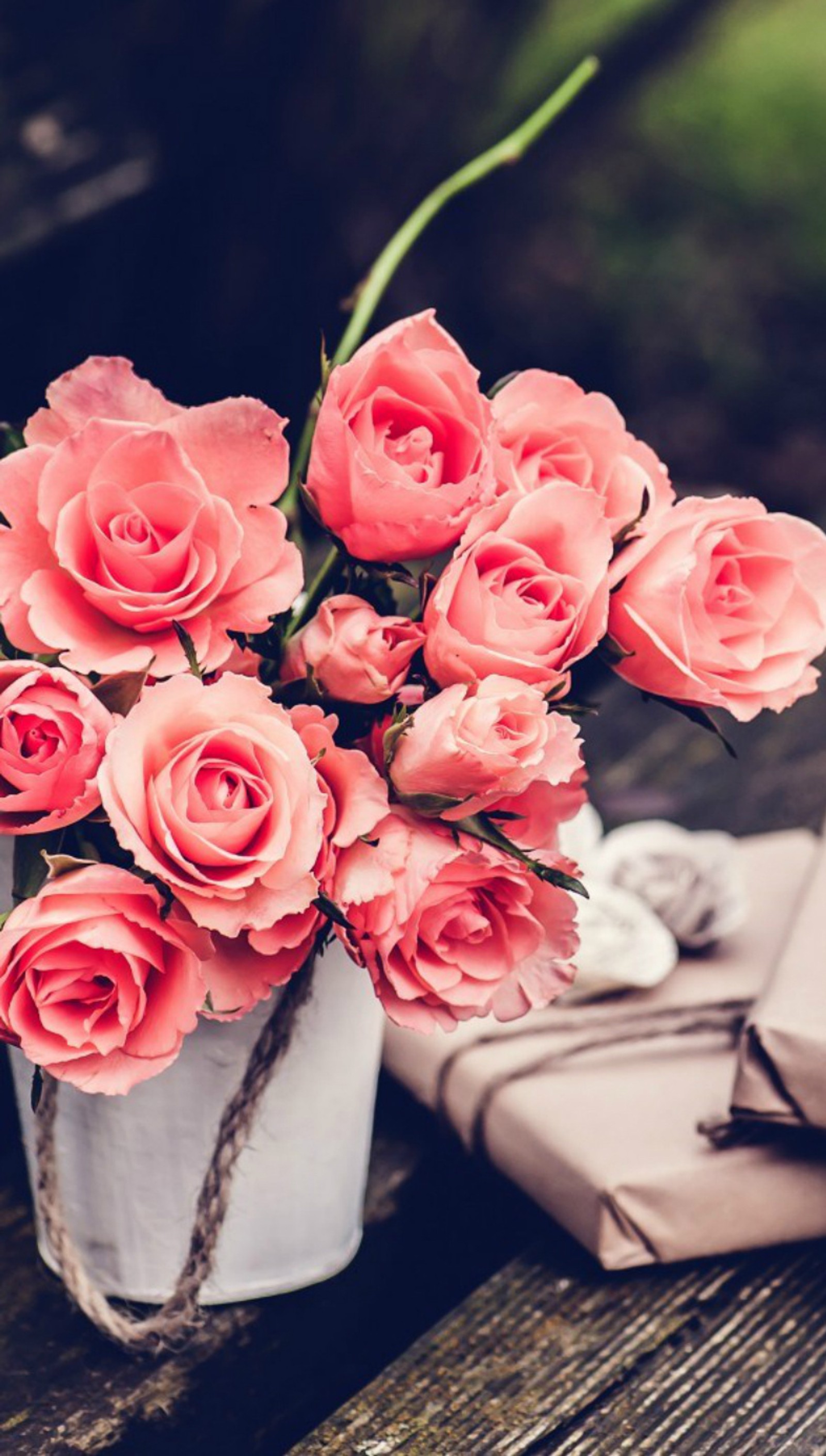 There is a vase of pink roses sitting on a table (flowers, pink, retro, vintage)