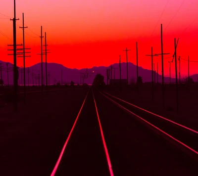 Sunset Silhouette of Train Tracks and Power Lines