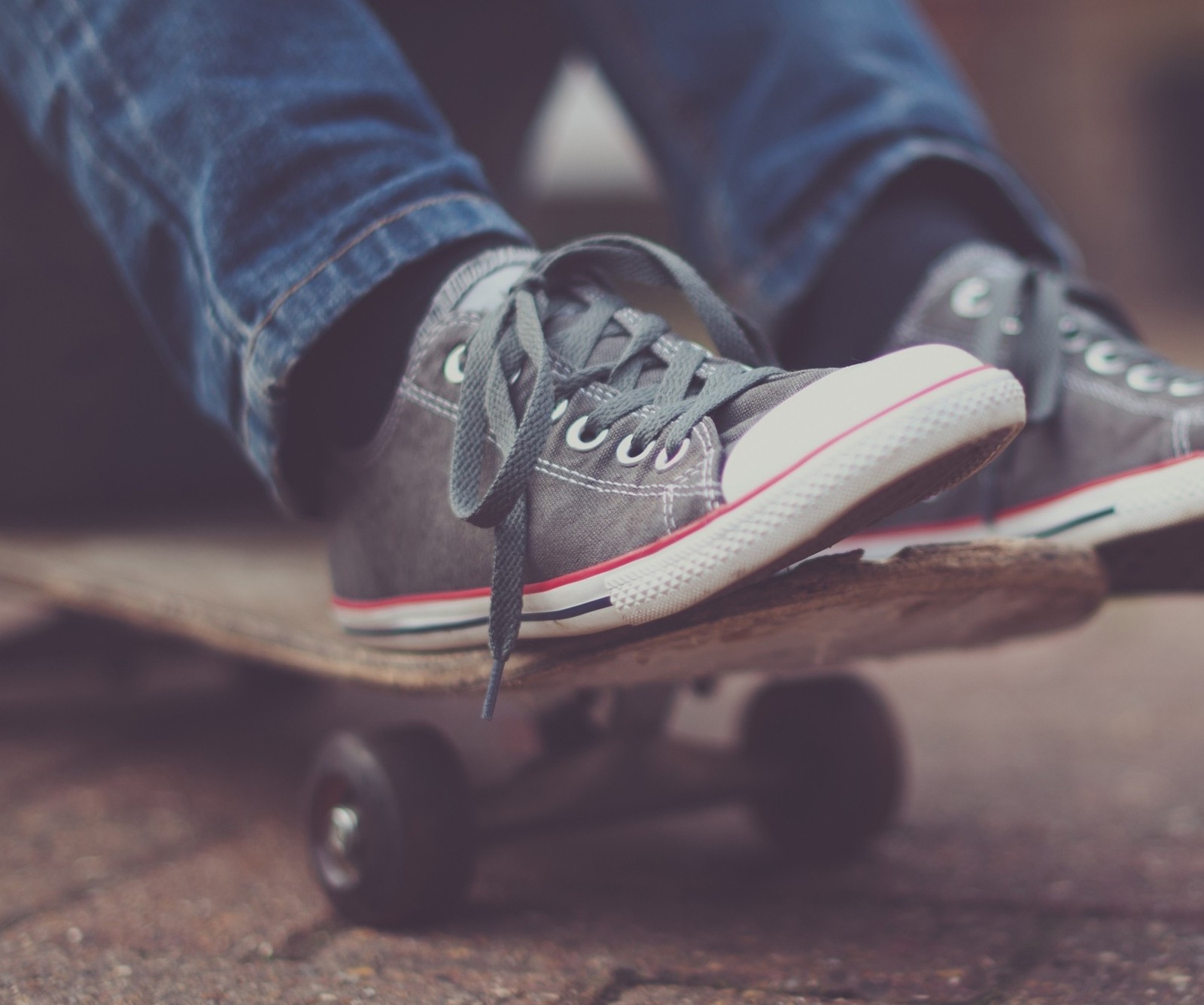 Someone is riding a skateboard on a sidewalk with their feet on it (2013, cool, hd, new, nice)