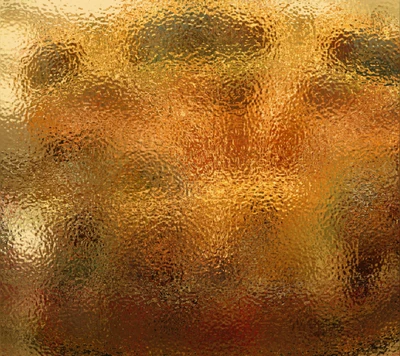 Papel de parede abstrato dourado texturizado com um fundo desfocado em tons quentes.