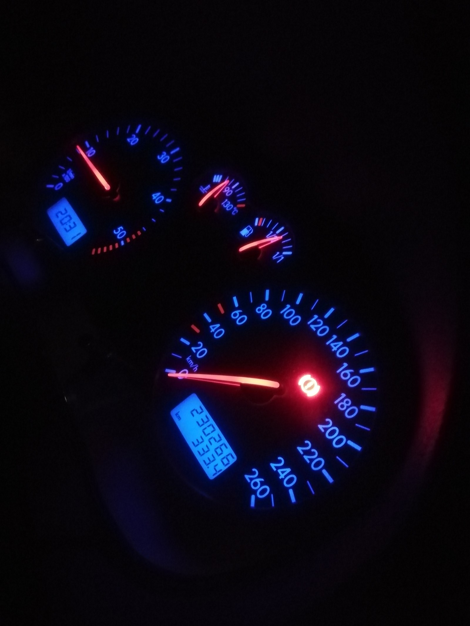 A close up of a car dashboard with a speedometer and a clock (golf, speed)