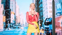 Sunny in a vibrant outfit against a colorful urban backdrop.