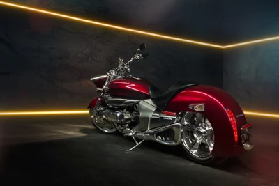 Sleek red motorcycle with chrome accents showcased in a modern illuminated setting.