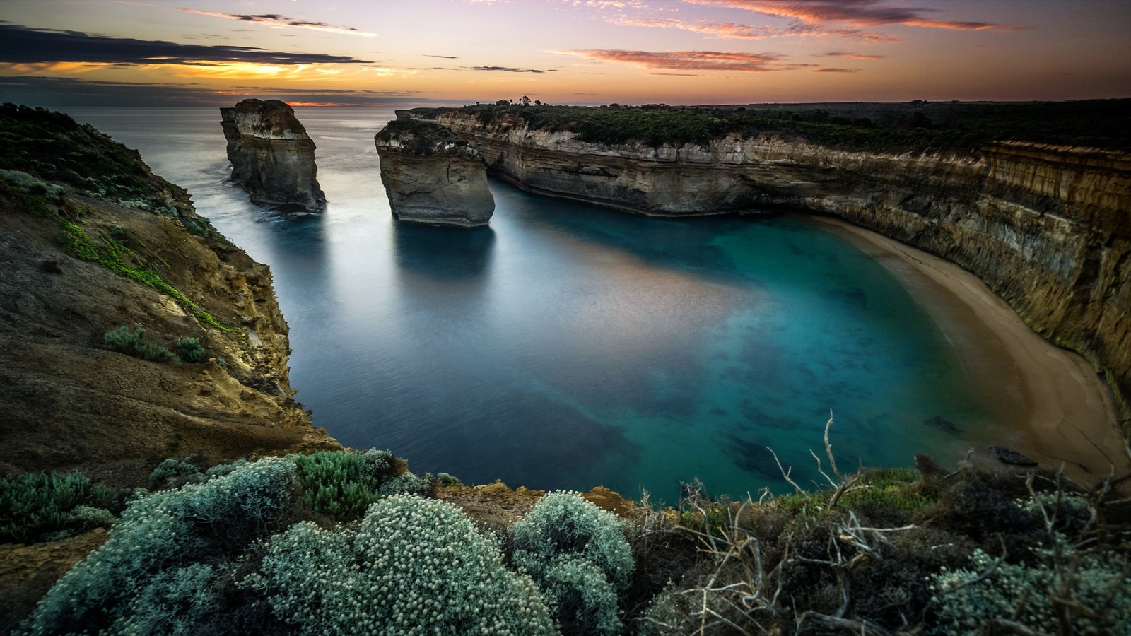 A view of a beach with a body of water and a cliff (nature, water, coast, sea, cove)