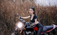 Stylish Woman on a Sport Motorcycle in a Natural Setting