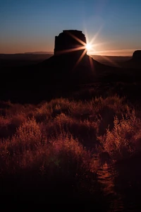 Sunset Over a Majestic Landscape with Silhouetted Rock Formation