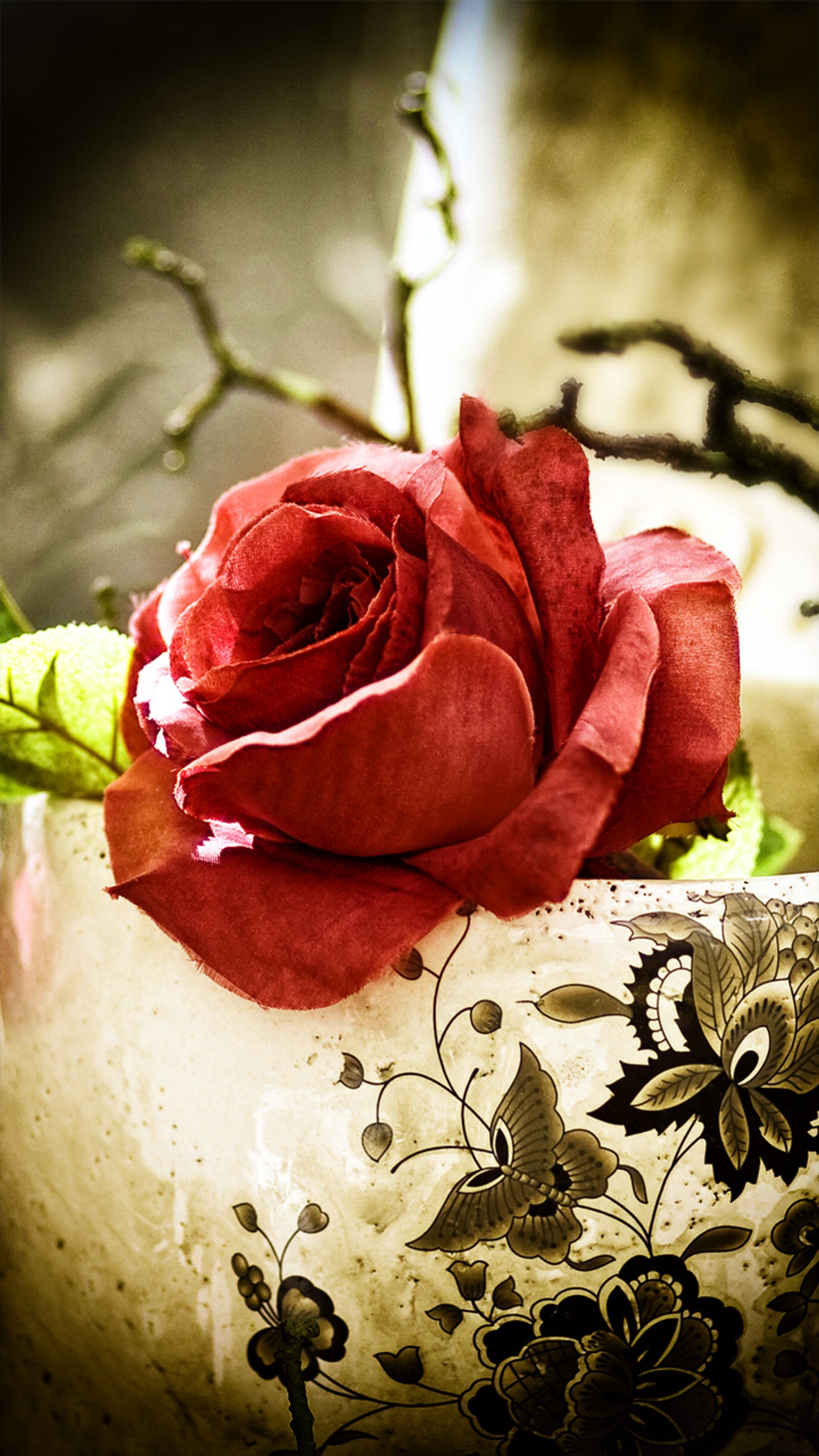 There is a red rose in a white vase with a black and white pattern (beauty, nature, red, red rose, rose)