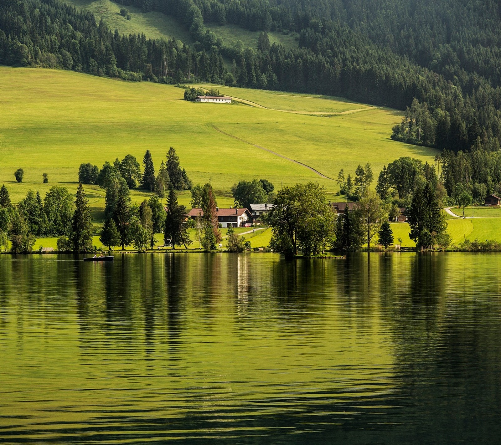 There is a small house on the shore of a lake (landscape, nature)