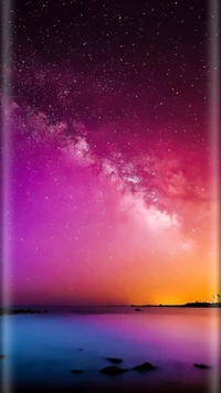 A stunning galaxy view with a vibrant pink and purple gradient, showcasing stars against a twilight horizon.