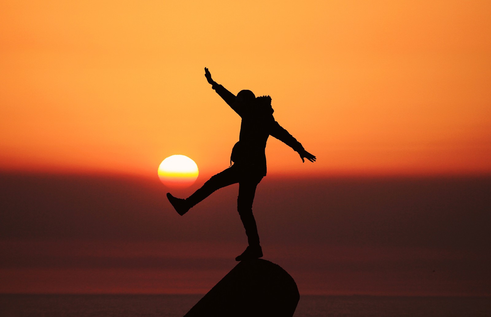 silhouette, person, balance, sunset, orange sky wallpaper