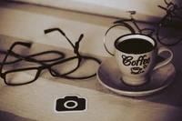 Still Life: Coffee Cup with Glasses and Camera Icon