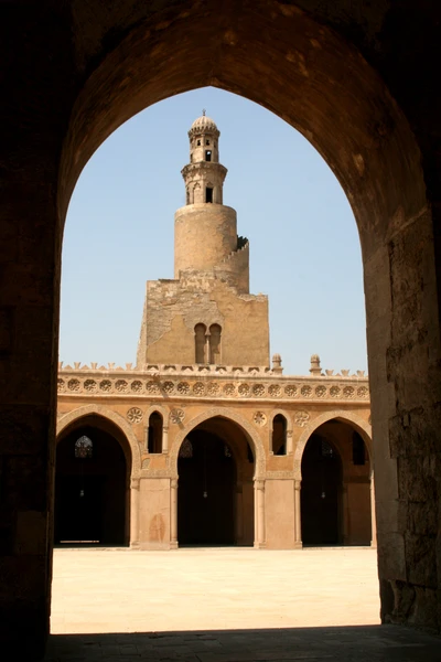 View of a Historic Mosque Minaret Through an Arched Entrance