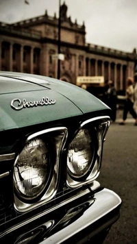 Classic Chevrolet Chevelle with vintage headlights in an urban setting.