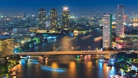 Vibrant Night Cityscape with Skyscrapers and Illuminated Bridge