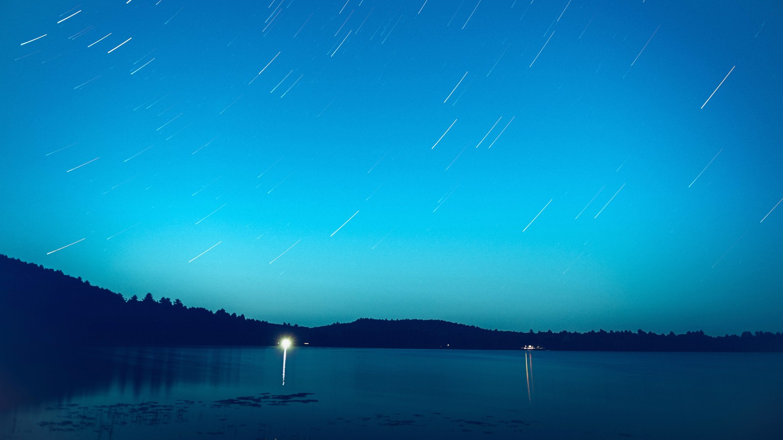 Arafed view of a lake with a boat and a star trail (night, sky, lake, scenery)