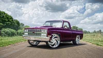 Classic Chevrolet Pickup with Custom Wheels on Scenic Country Road