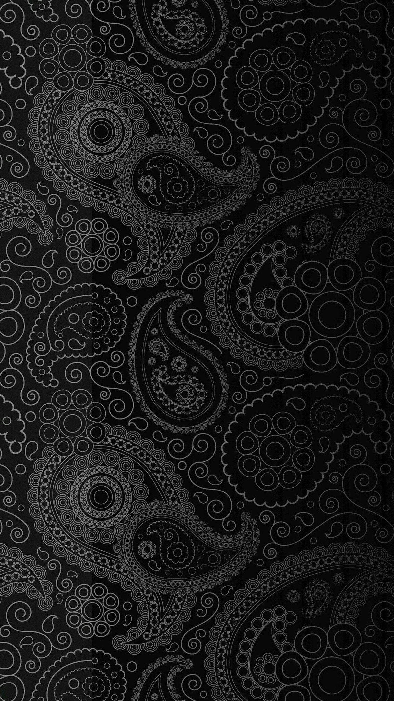 Primer plano de un patrón paisley en blanco y negro sobre un fondo negro (marrón, textil, gris, arte, estilo)